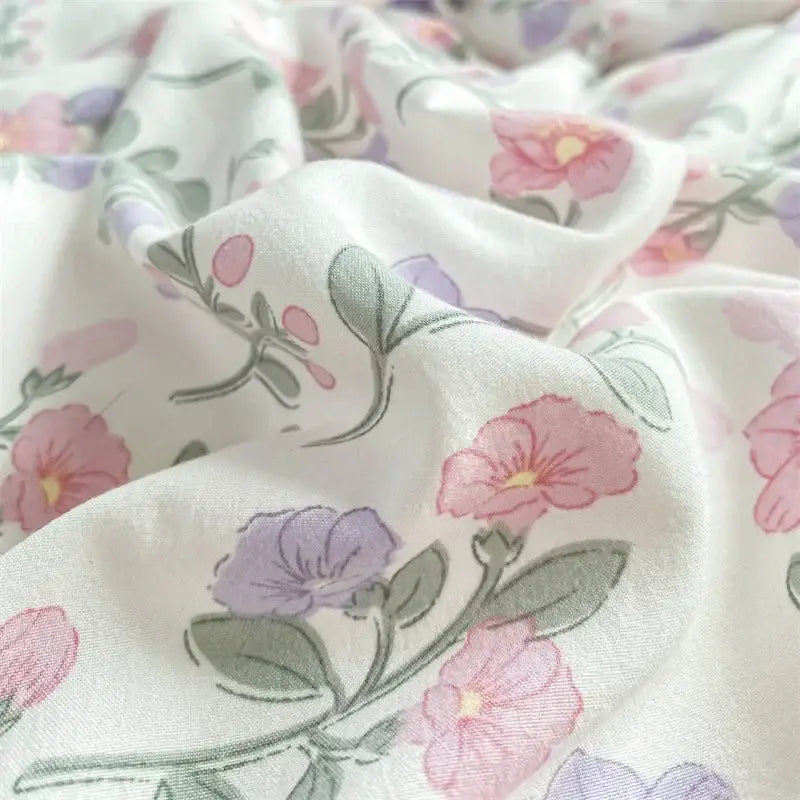 Soft white bed sheet with delicate pink and lavender flowers on double layer yarn cozy fabric for bedroom use