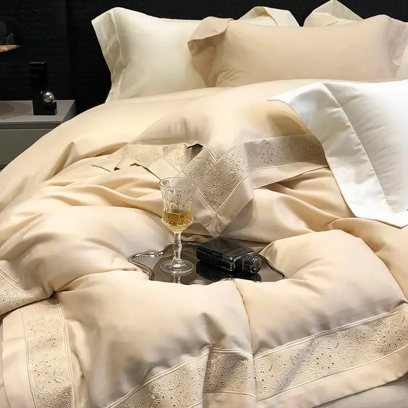 Cream-colored satin bedding set with delicate lace trim and embroidery from decorbites 1200tc luxury embroidery collection