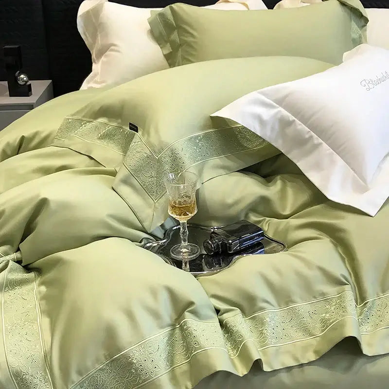 Luxurious sage green satin bedding set with intricate embroidered lace trim and pillowcases in decorbites 1200tc luxury