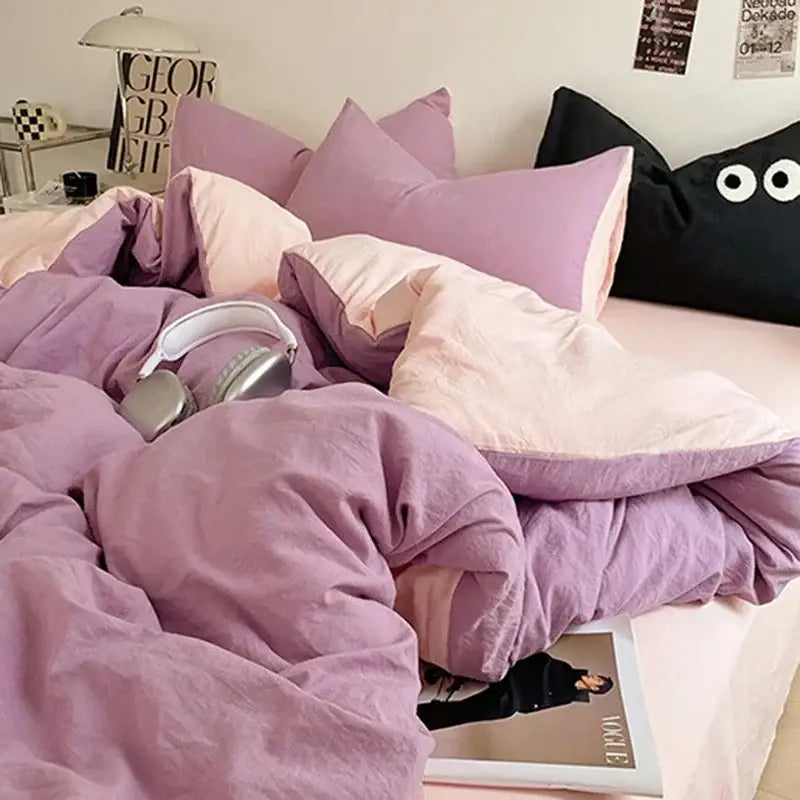 Cozy lavender and black cotton bedding set with soft textured duvet and matching pillows in shades of purple and pink