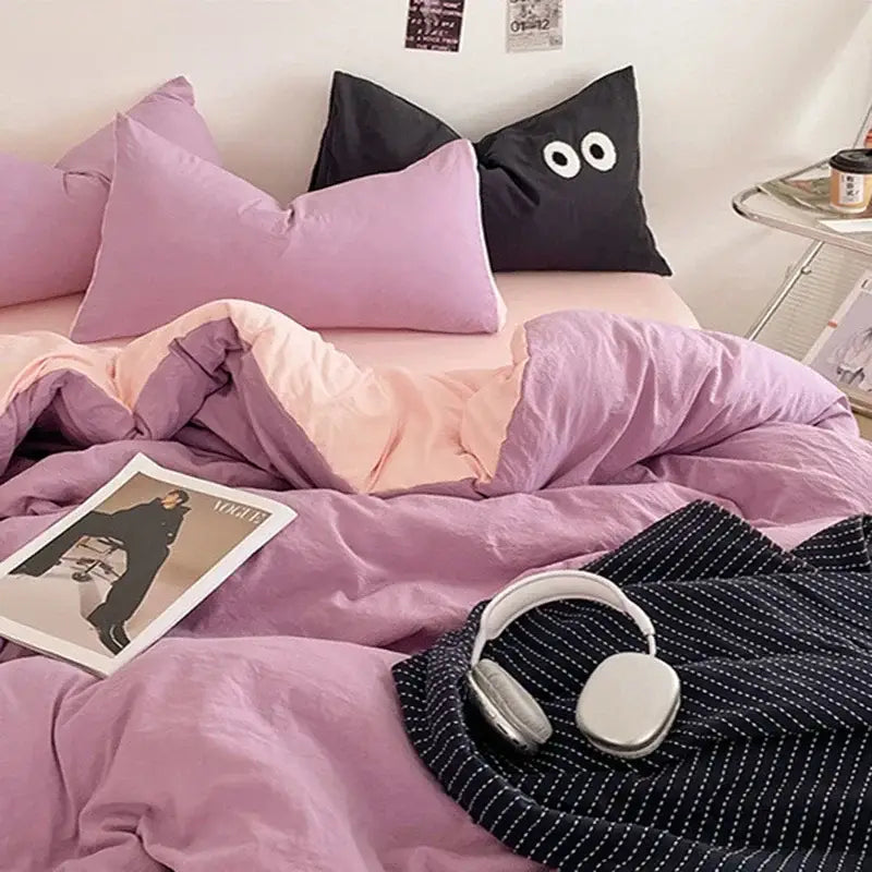 Lavender and black cotton bedding set with a purple and pink duvet and black pillow featuring white eye appliqués