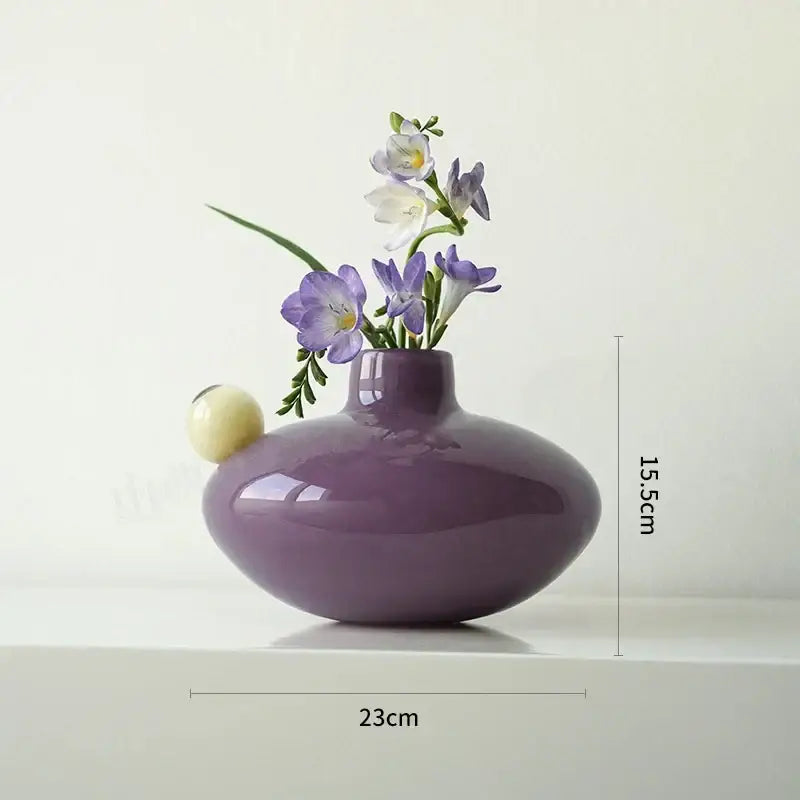 A sleek glossy purple ceramic vase with an off-white accent for living room decorbites geometric glass vase