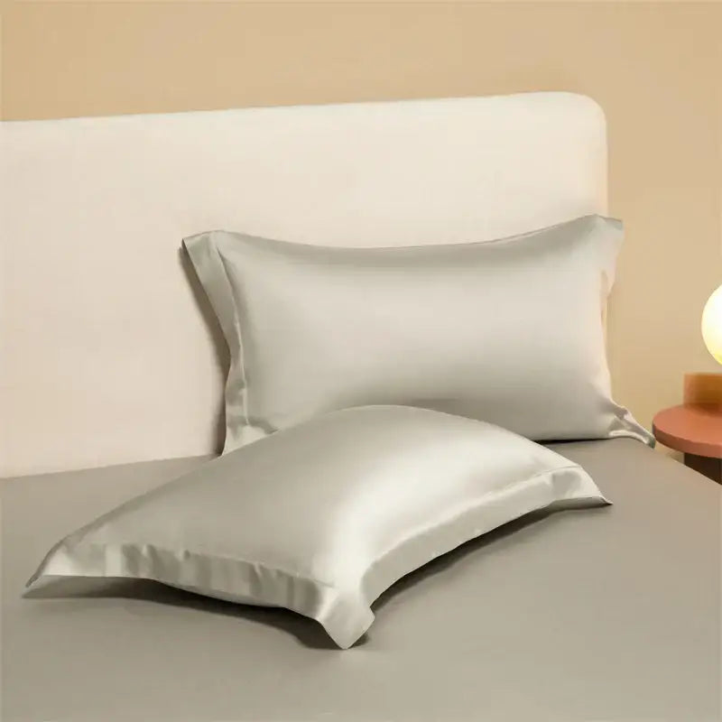 Two elegant silver satin egyptian cotton pillowcases with smooth glossy finish in a cotton pillowcase set