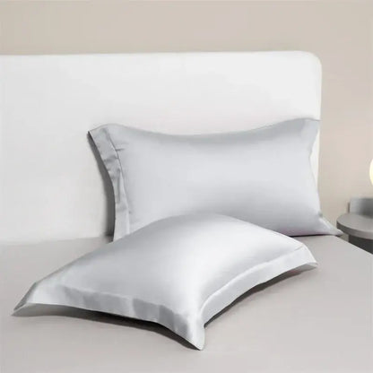 Two elegant white egyptian cotton pillowcases with subtle sheen and stitched edges in a cotton pillowcase set