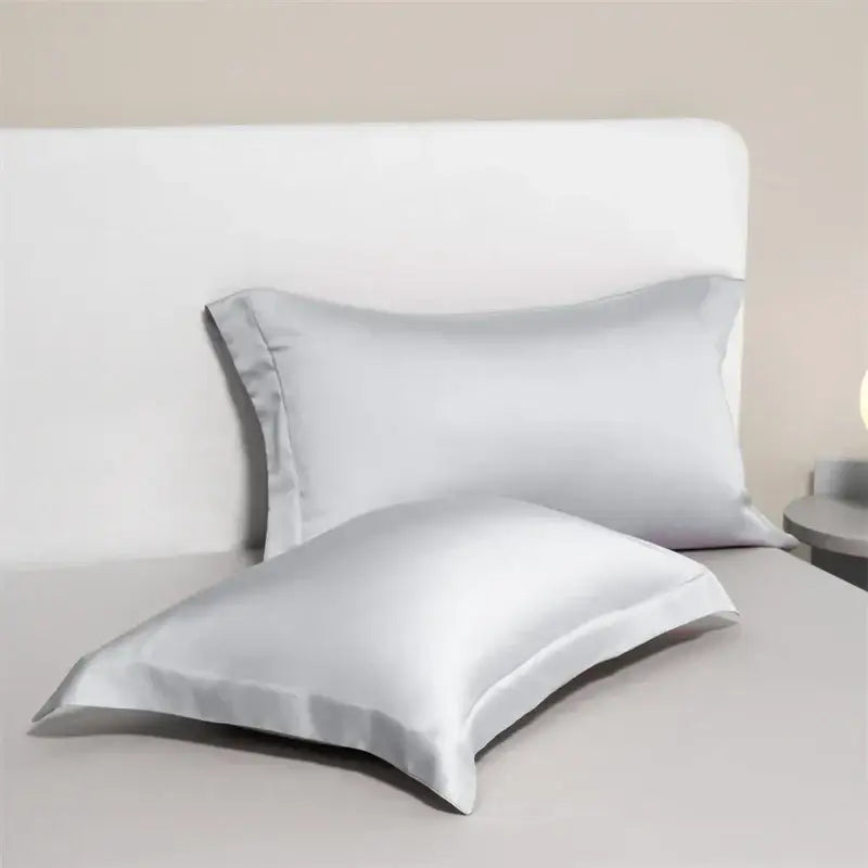 Two elegant white egyptian cotton pillowcases with subtle sheen and stitched edges in a cotton pillowcase set