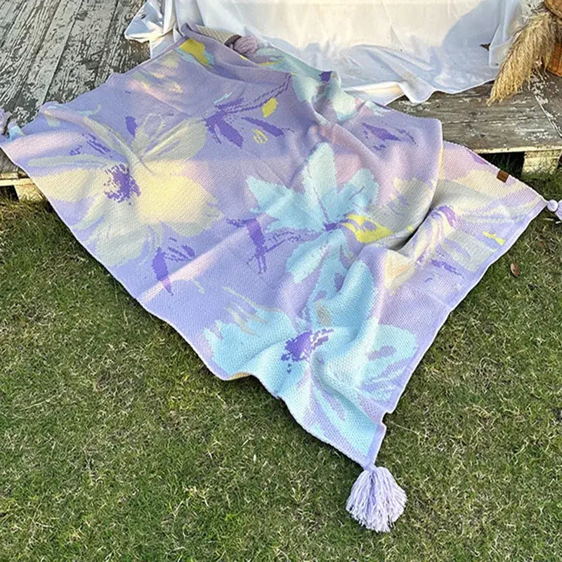 A decorbites cozy knit lavender floral cozy knit blanket with vibrant blue yellow purple flowers and tassels