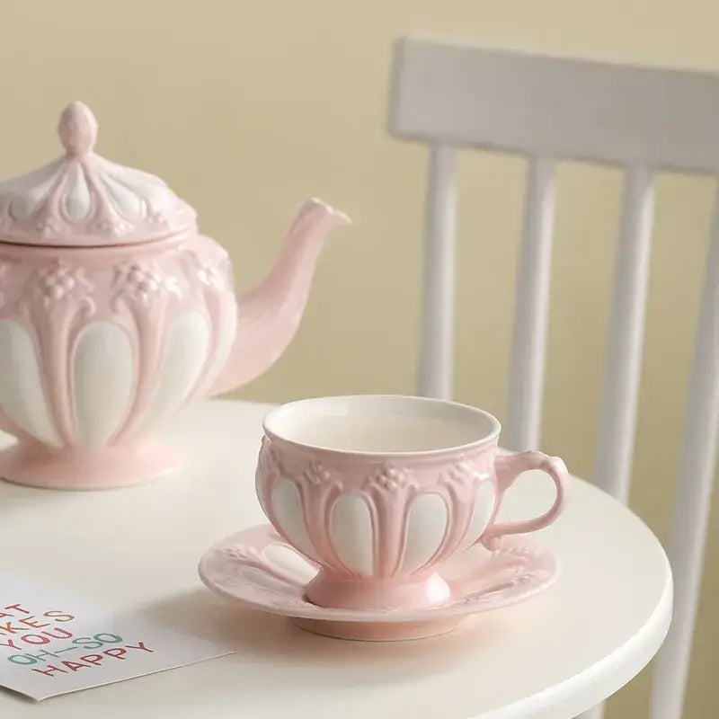 Pink ceramic teacup with white floral embossed patterns and matching saucer from decorbites elegant porcelain tea set