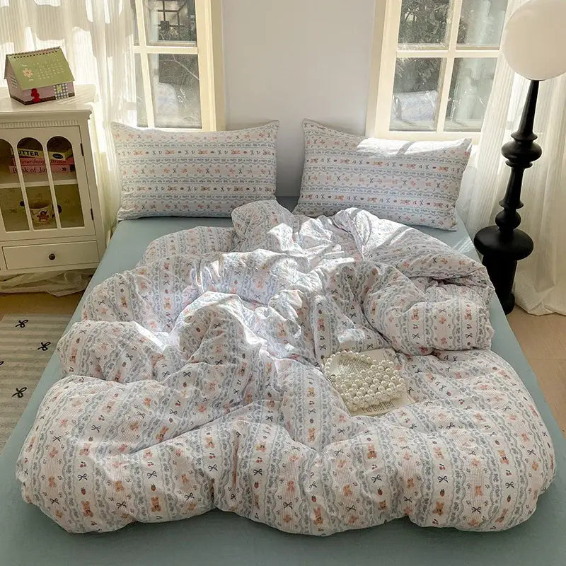 A cozy light blue and white floral cotton bedding set featuring textured lavender floral design for bedroom use
