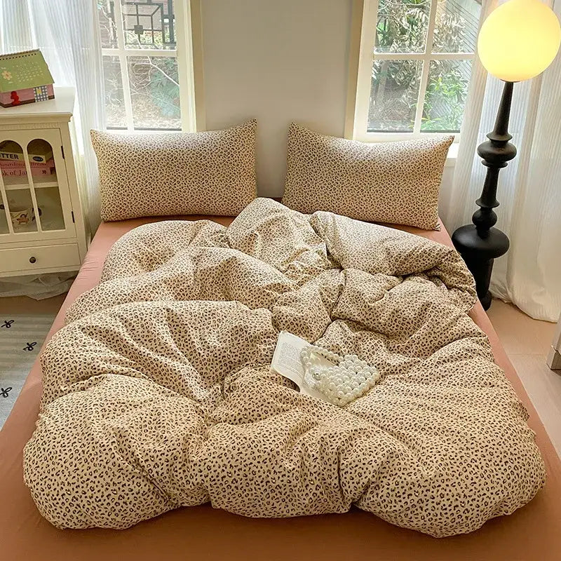 Cream-colored leopard-print cotton bedding set with soft plush texture and matching pillows for bedroom quilt use