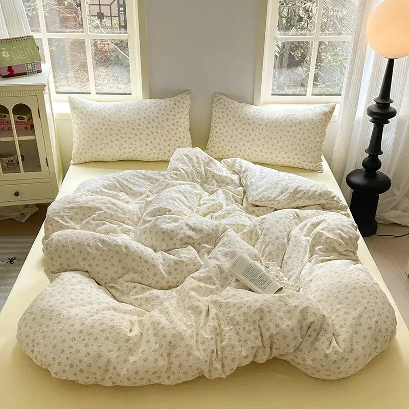Cream-colored lavender floral textured cotton bedding set with quilt and matching pillows in soft cotton fabric