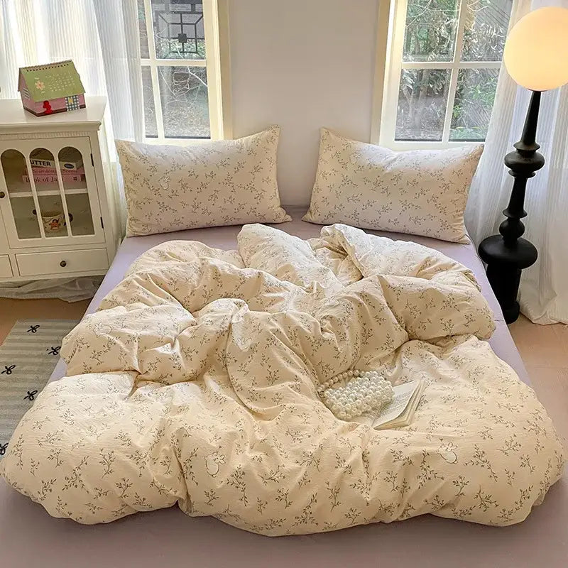 Cream-colored floral patterned cotton bedding set with soft cozy texture and matching pillows for bedroom use
