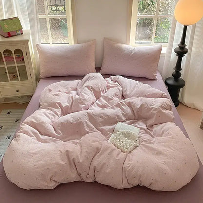 Pink corduroy duvet set with subtle dot pattern as part of a lavender floral textured cotton bedding set for bedroom use
