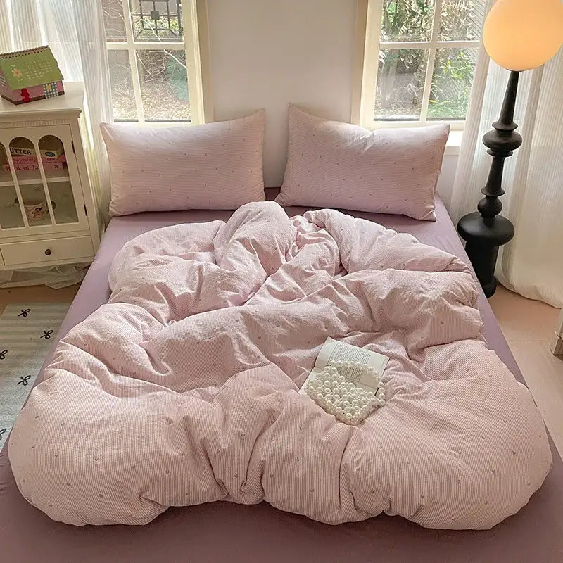 Pink corduroy duvet set with subtle dot pattern as part of a lavender floral textured cotton bedding set for bedroom use