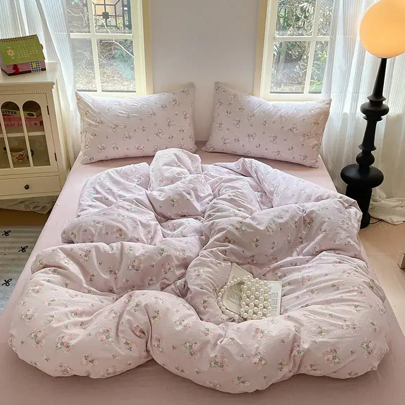 Pink floral-patterned cotton bedding set with soft plush texture and matching pillowcases for bedroom quilt use