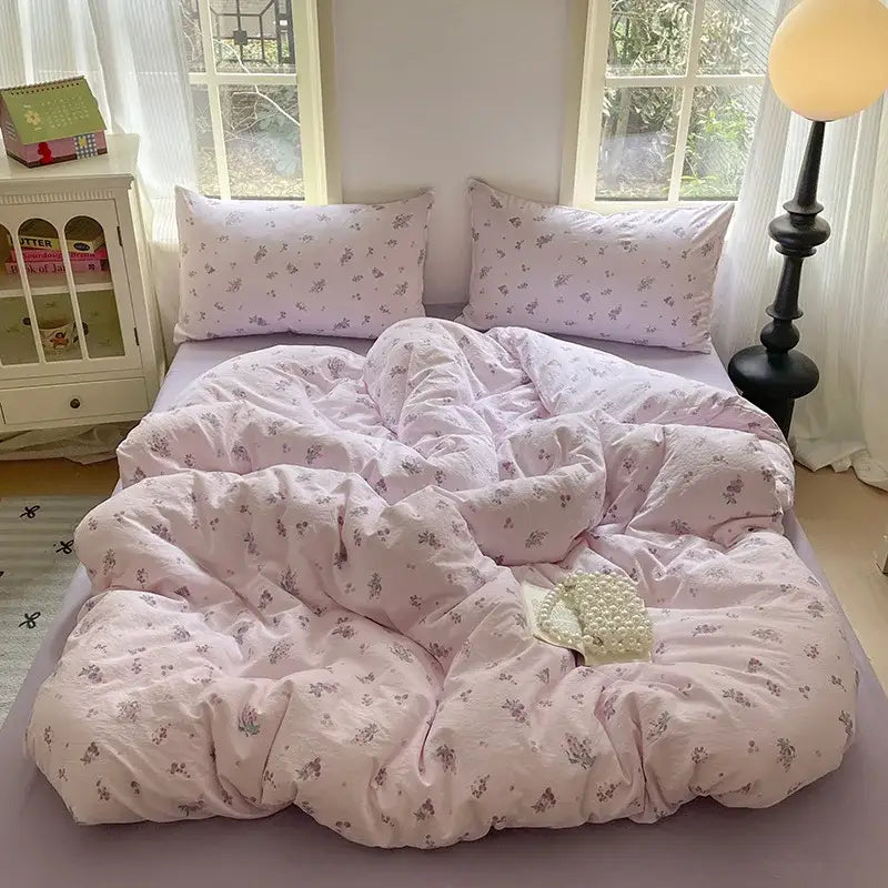 Pink floral-patterned cotton bedding set with soft cozy texture and matching pillows for bedroom quilt use