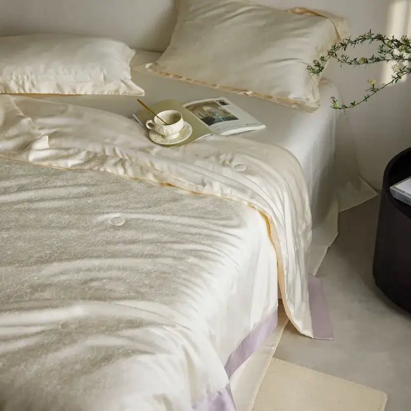 Cream-colored satin duvet cover with subtle embroidery and lavender trim in decorbites light luxury jacquard quilt set