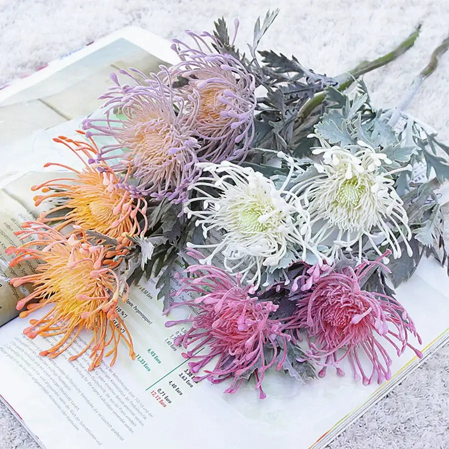A bouquet of decorbites artificial crab claw flowers in lavender peach white and pink with textured green leaves for decor