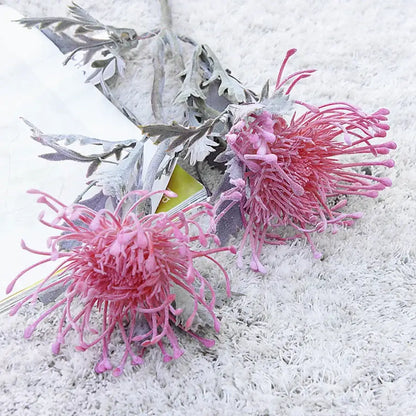 Lavender and orange artificial crab claw branch with pink artificial protea flowers and silver-gray foliage for decorbites artificial crab decor