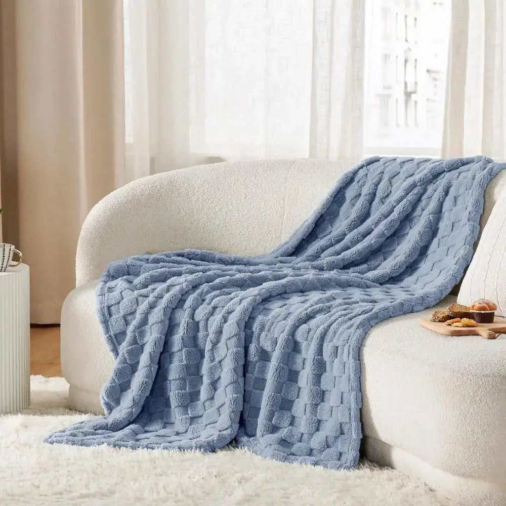 Soft light blue knitted throw blanket with chunky weave draped on cream sofa decorbites cozy fluffy blanket decorbites cozy