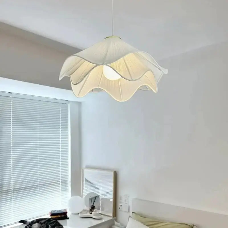 Layered white fabric pendant light with cream-colored petal-shaped shade and gold trim for dining room decorbites led white