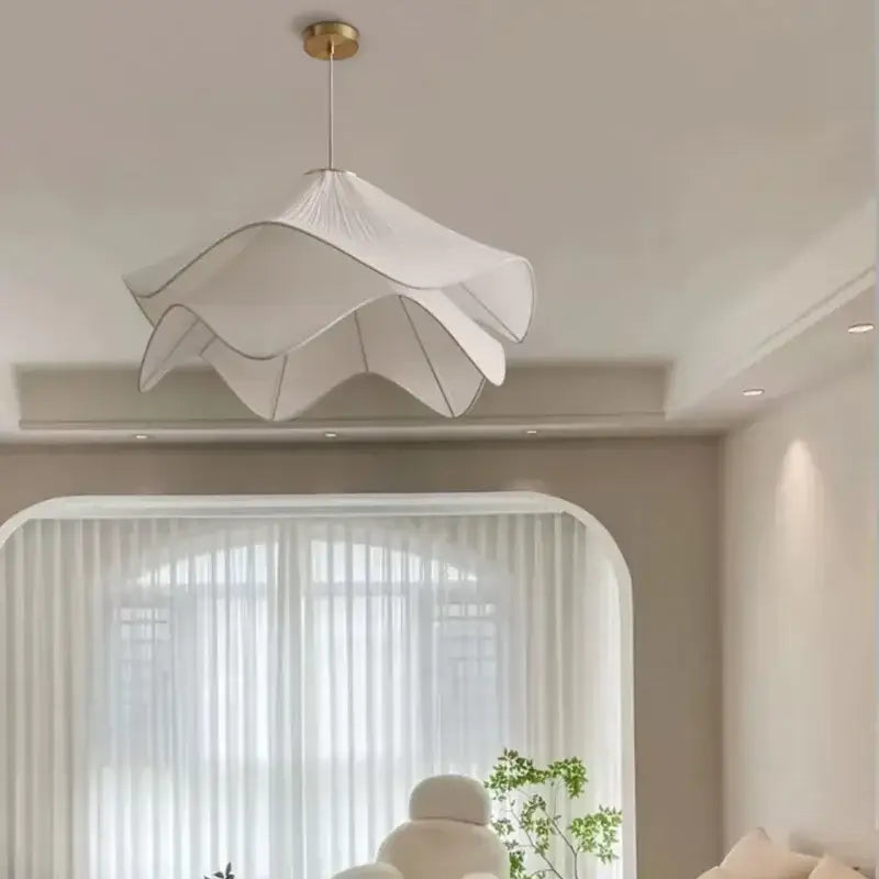 Layered white fabric pendant light with ruffled petal design and gold-toned fixture for dining room decorbites led white