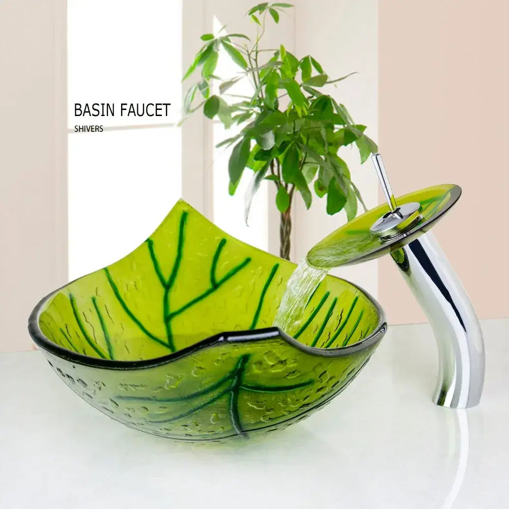Vibrant green glass vessel sink set featuring a leaf shaped glass vessel sink with sleek chrome waterfall faucet by Shivers