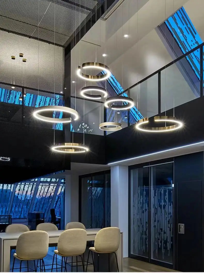 Modern led chandelier light with gold metallic circular frames and glowing white led rings for dining room or kitchen