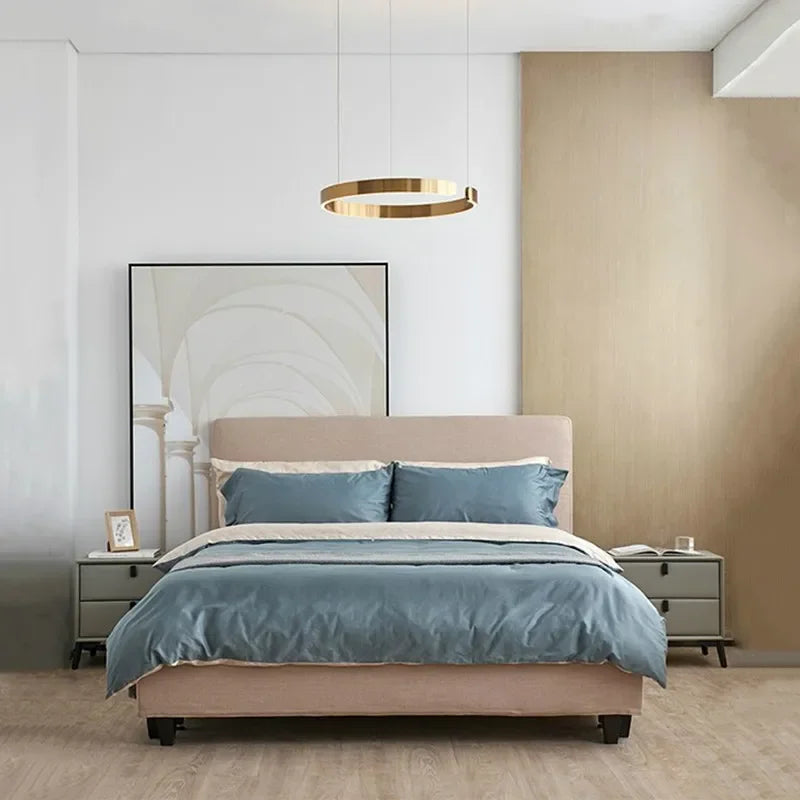 Beige upholstered bed with soft blue duvet under modern gold led chandelier light for study dining bedroom use