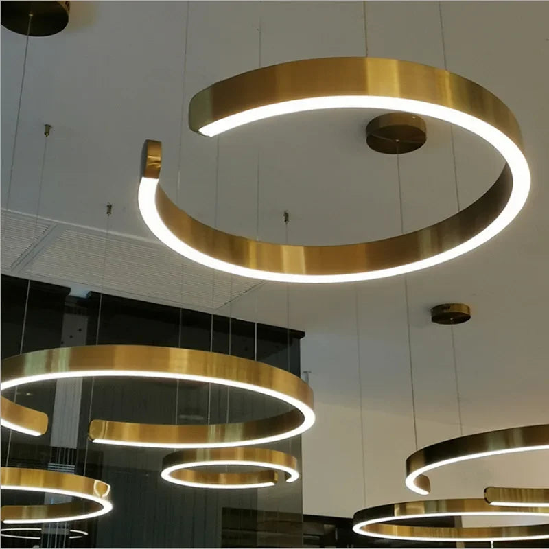 Gold-colored led chandelier light with circular rings and integrated led for modern dining and study rooms