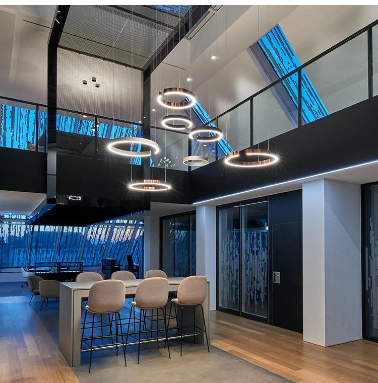 Modern round rings style led chandelier light with warm gold finish hanging in study dining room or kitchen bar