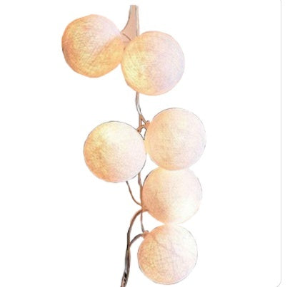 Peach-colored cotton ball garland with a rose gold wire.