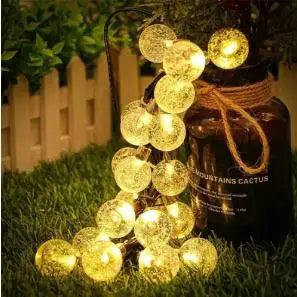 Warm white led solar crystal globe string lights with golden glass globes and rustic twine for outdoor use