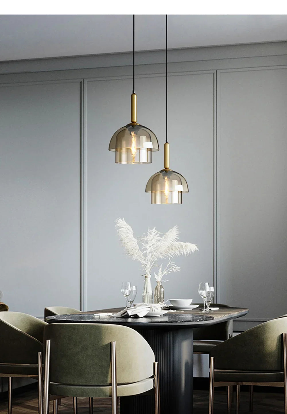 Two elegant brass-finished led vintage art champagne glass pendant lamps with smoked domes hang above dining table