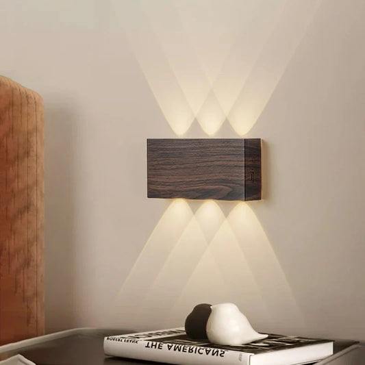 Rectangular wooden wall sconce with upward and downward light beams.