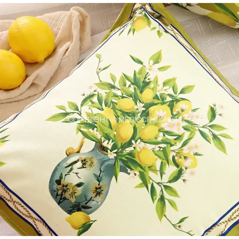 Cream-colored lemon print chenille cushion cover with vibrant lemons and green leaves in blue vase decorbites lemon print