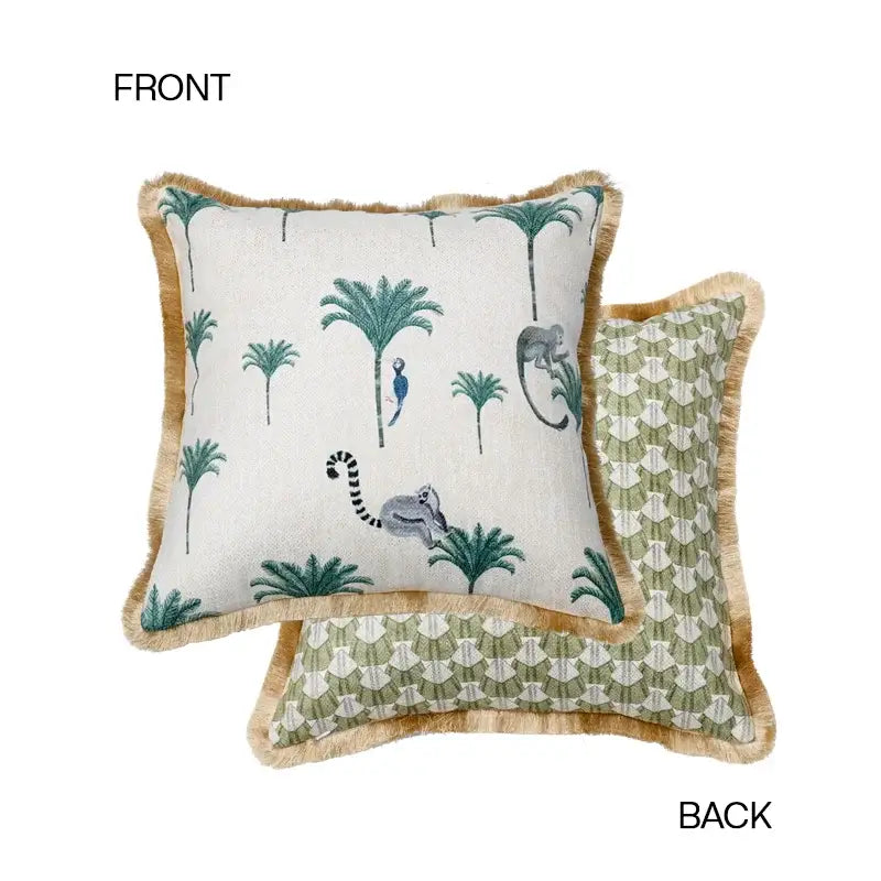 Square leopard decorative cushion cover with white front, embroidered green palm trees, gray lemurs, and tan fringe border