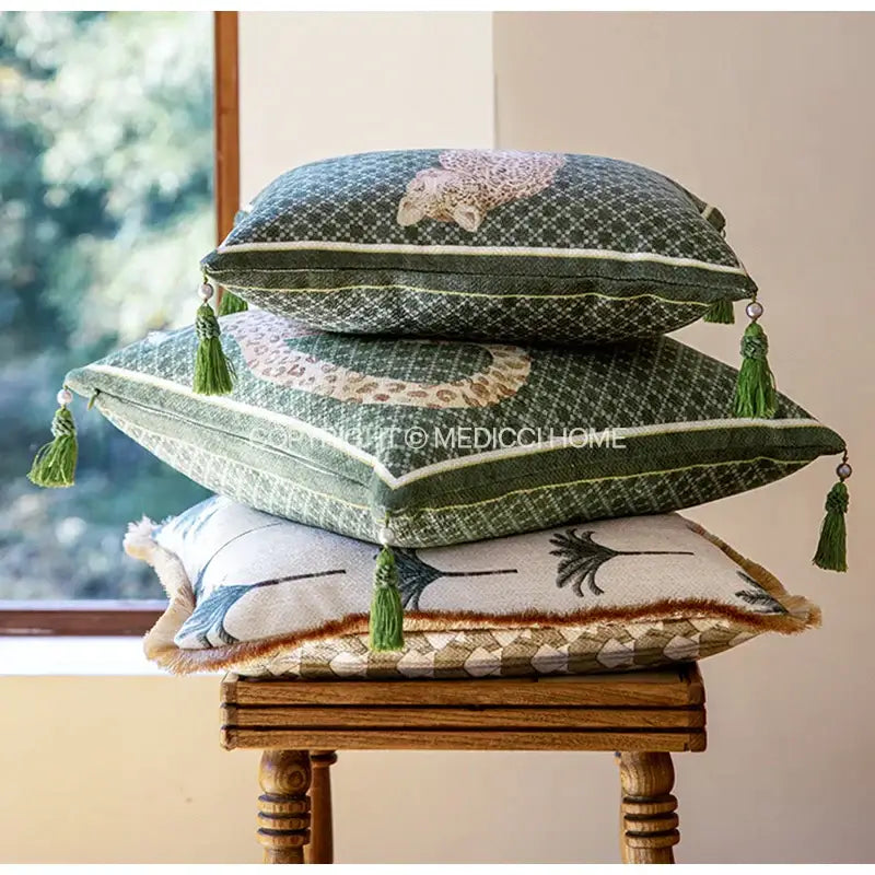 Stacked green decorbites leopard decorative cushion covers with tassel trim and embroidered animal motifs for living room decor