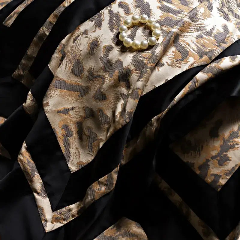 A circular pearl brooch on luxurious beige brown black decorbites leopard jacquard lyocell cotton bedding set fabric