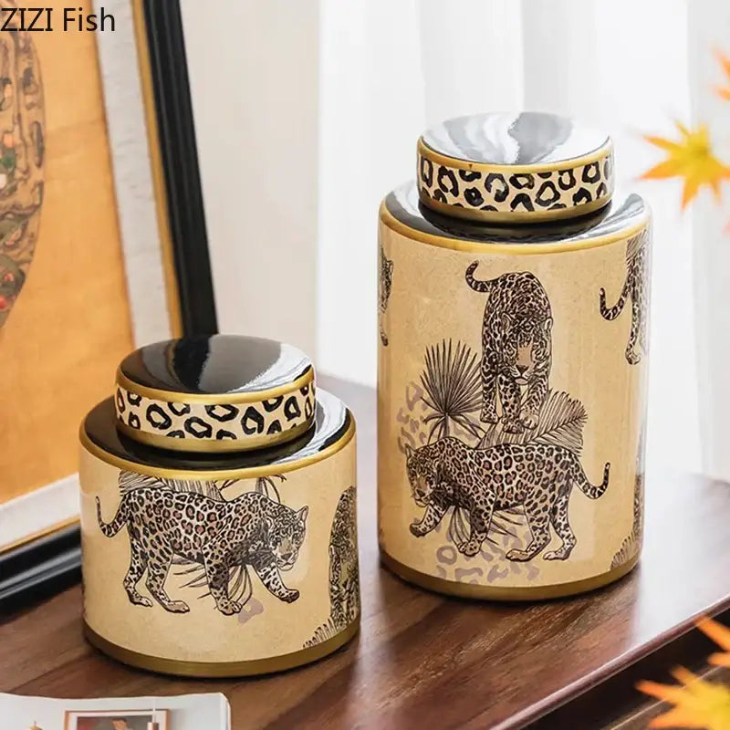Two beige ceramic storage jars with leopard pattern black illustrations on palm fronds by decorbites