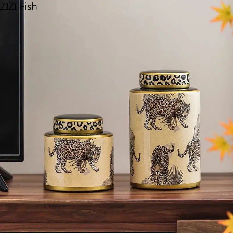 Two beige ceramic storage jars with gold rims and leopard pattern lids from decorbites leopard pattern collection