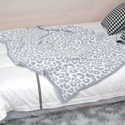 A soft gray and white leopard print cozy flannel velvet blanket with plush texture for bedroom or sofa decorbites cozy flannel