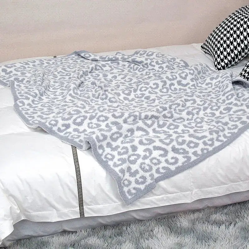 A soft gray and white leopard print cozy flannel velvet blanket with plush texture for bedroom or sofa decorbites cozy flannel