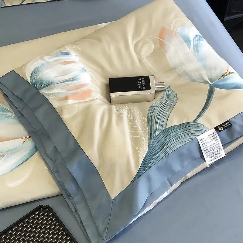 A silver and black perfume bottle on a cream and blue satin pillow sham with leopard print decorbites design