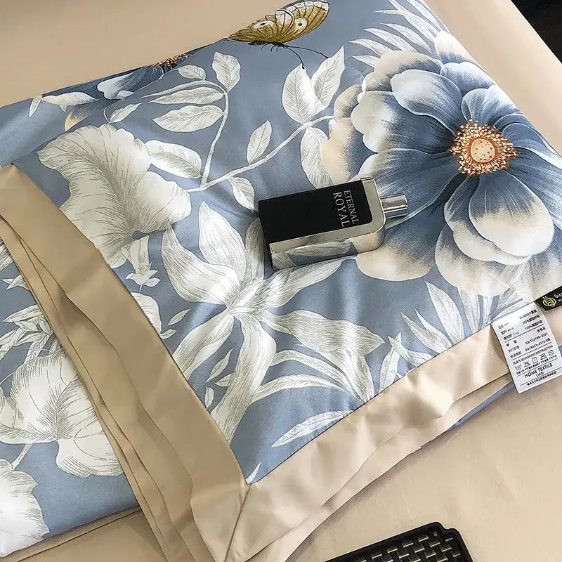 A sleek black and silver eternal royal perfume bottle rests on a leopard print cream and blue satin pillow sham decorbites leopard print