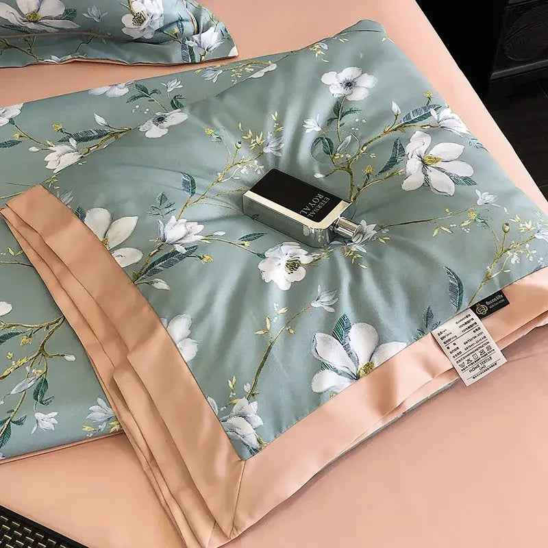 A soft sage green pillowcase with white floral embroidery and peach satin border in decorbites leopard print summer style bedroom decor
