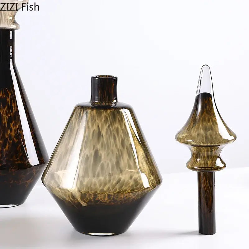 A sleek amber leopard print glass vase with faceted geometric design and dark brown base for decorbites decor