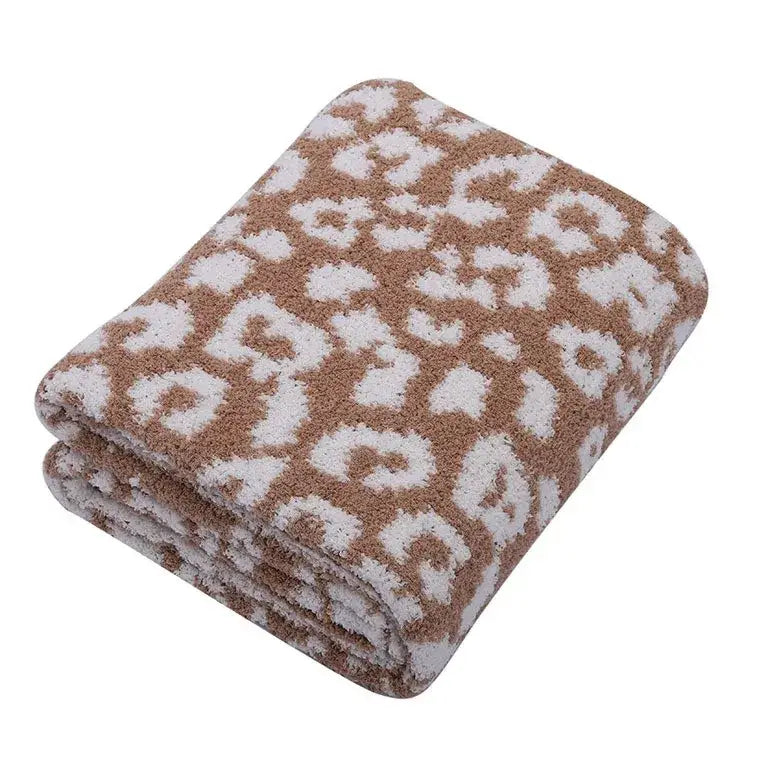A plush folded fleece blanket with soft brown and white leopard print for decorbites leopard print bedroom sofa throw