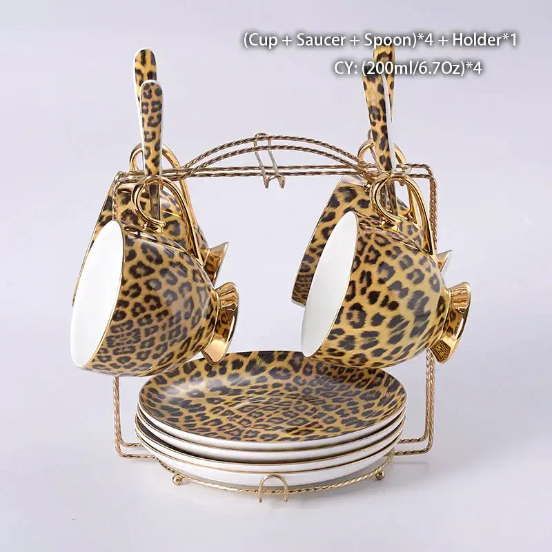 Leopard print porcelain coffee set with gold-trimmed ceramic cups, saucers, and spoons on a gold metal stand decorbites leopard print