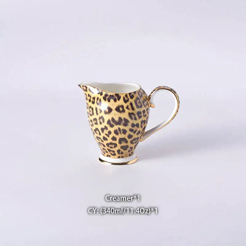 A delicate porcelain creamer with golden leopard print and gold-trimmed handle in decorbites leopard print coffee set