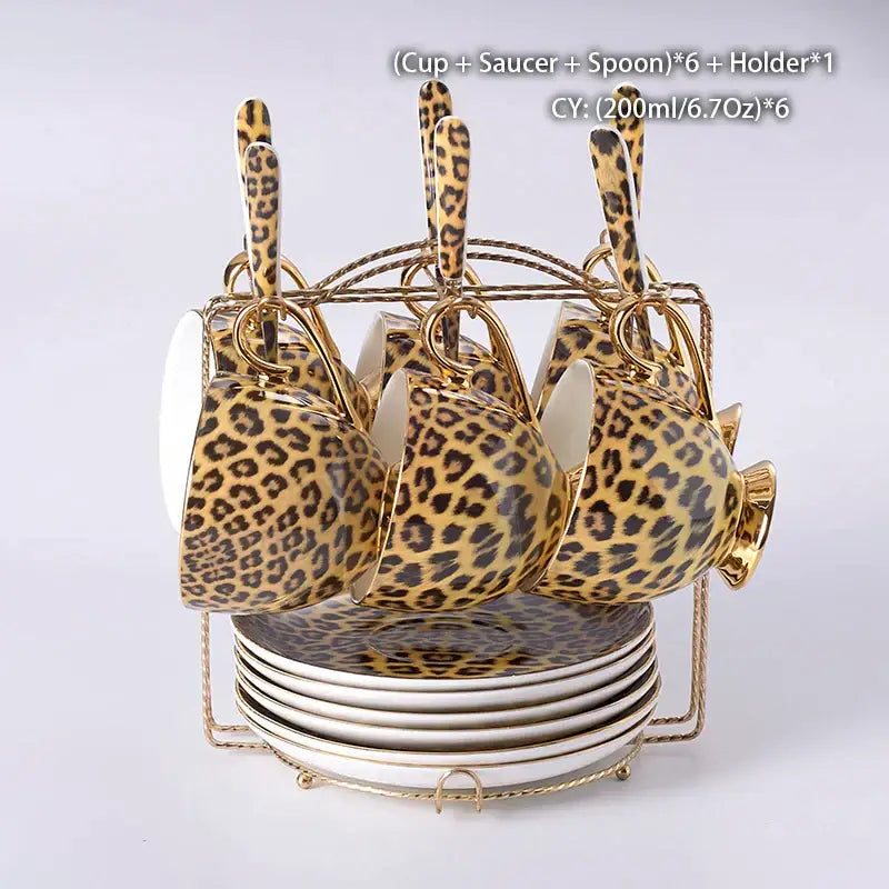 Set of six leopard print porcelain coffee cups with gold accents and matching saucers in a gold-toned holder decorbites leopard print